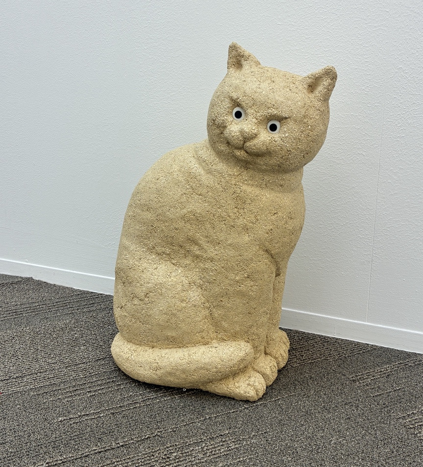 Sand sculpture of a seated cat
