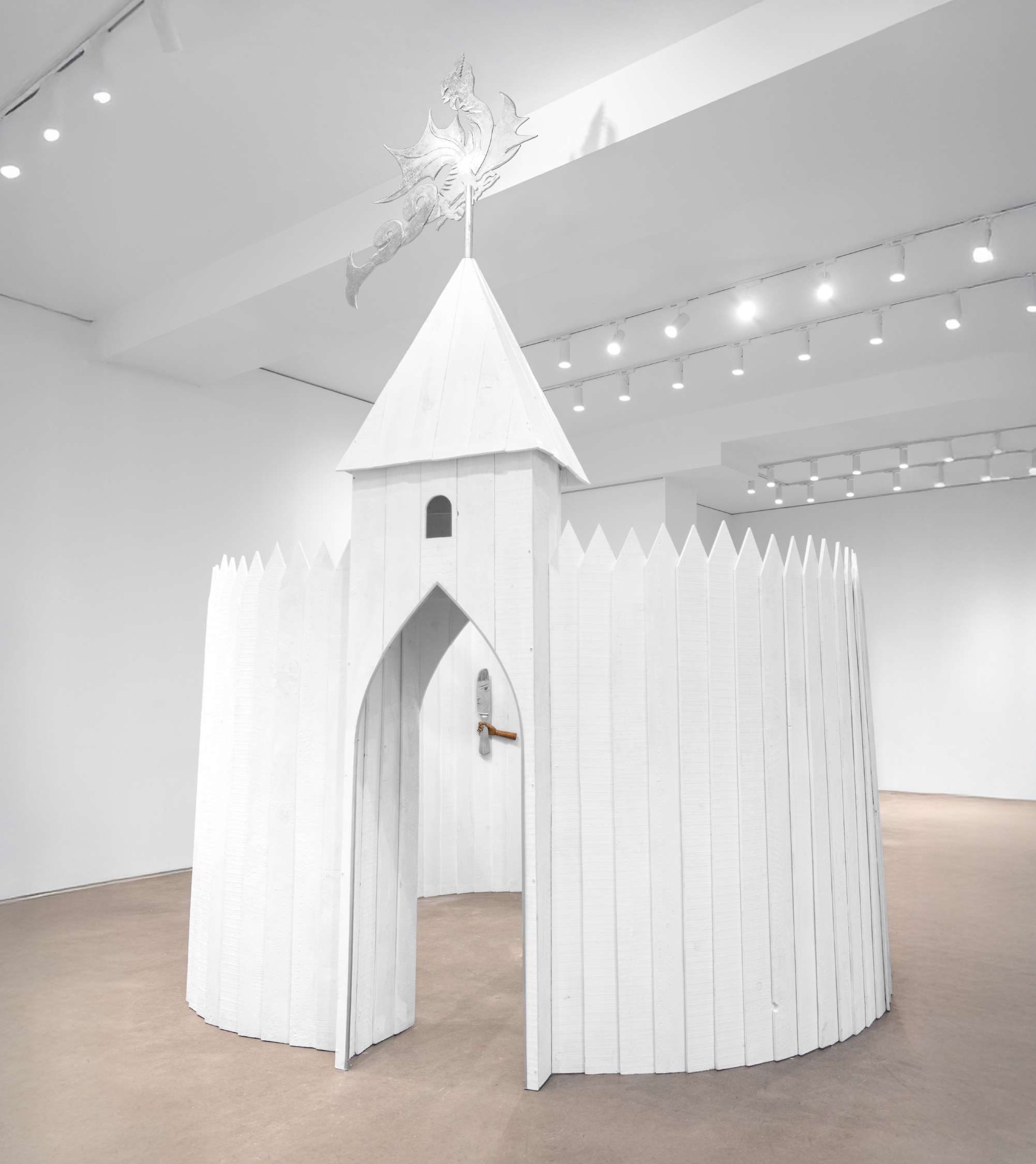 White wooden castle installation in a gallery