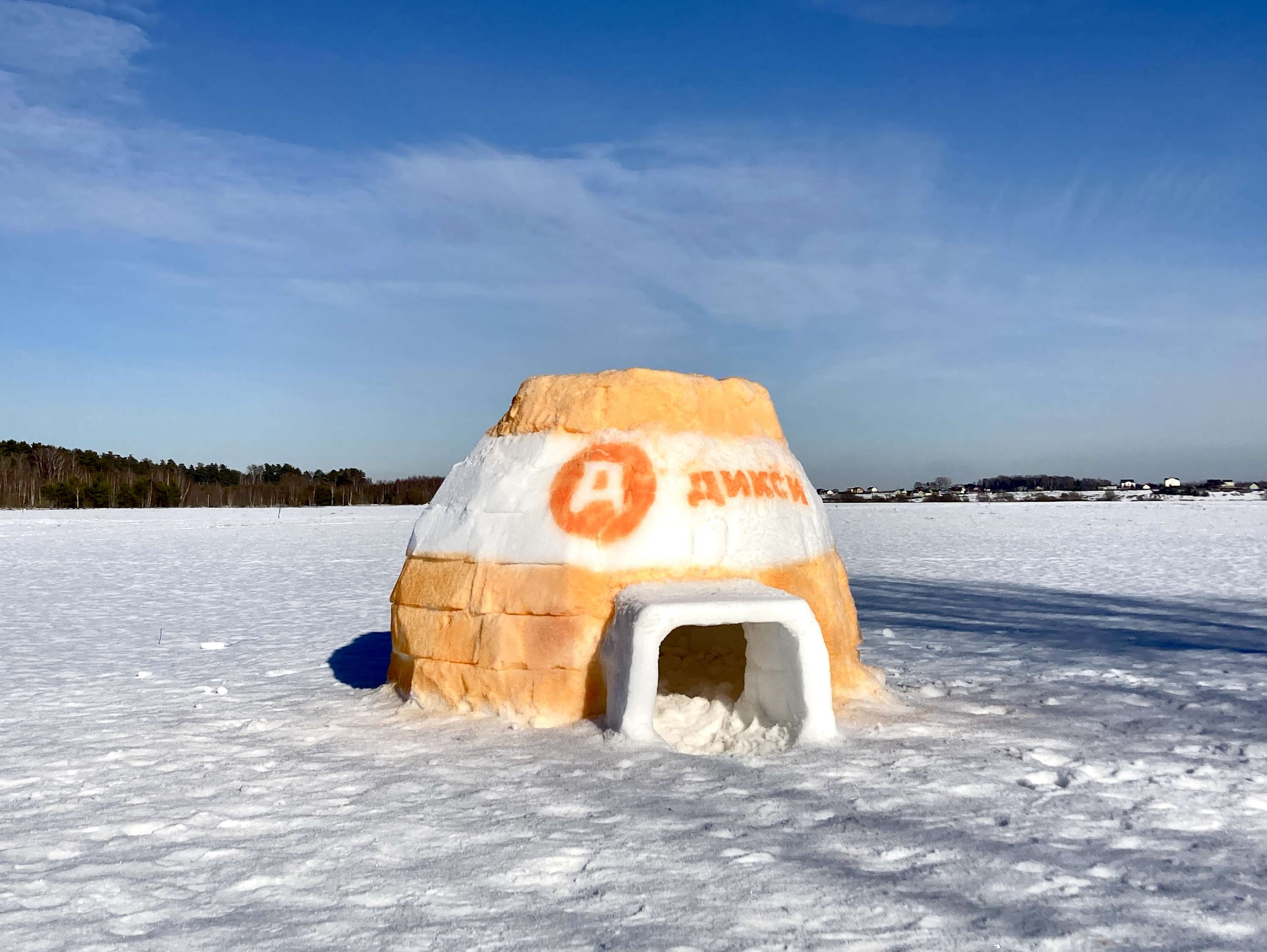 Snow sculpture by an orange shelter
